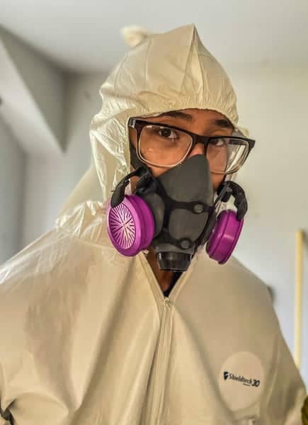 Certified mold technician in protective equipment