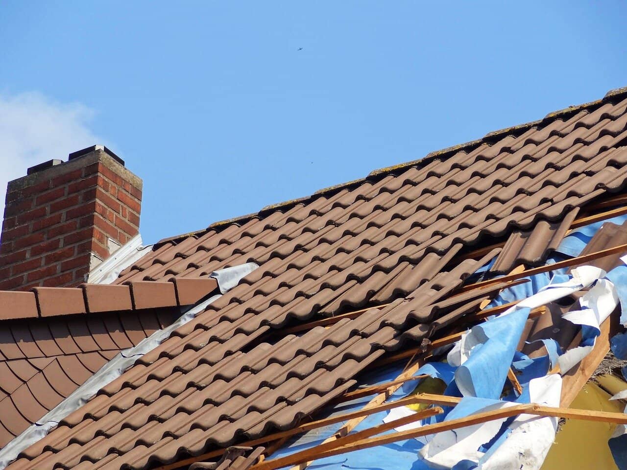 Severe storm damage to residential roof in Greater Philadelphia area showing structural damage from high winds and hail